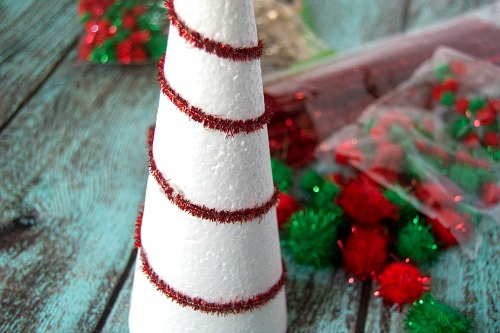 DIY Dollar Store Pom Pom Christmas Tree- Add pretty (and inexpensive) decor to your Christmas table or mantel with this DIY dollar store Christmas tree centerpiece! | Christmas craft, holiday DIY, pom pom Christmas tree, dollar store craft, #Christmas #DIY #ACultivatedNest