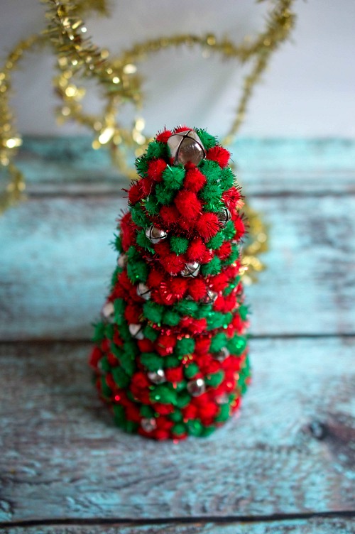 Pom Pom Christmas Tree Decor DIY- Add pretty (and inexpensive) decor to your Christmas table or mantel with this DIY dollar store Christmas tree centerpiece! | Christmas craft, holiday DIY, pom pom Christmas tree, dollar store craft, #Christmas #DIY #ACultivatedNest