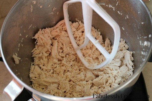 Shred Chicken with a KitchenAid Mixer- Your stand mixer is good for more than just mixing up desserts! Take advantage of all your mixer can do with these 15 KitchenAid mixer hacks and tips! | ways to use your KitchenAid mixer, things your stand mixer can do, mixer DIY play dough, shred chicken, #hacks #kitchenaid #ACultivatedNest
