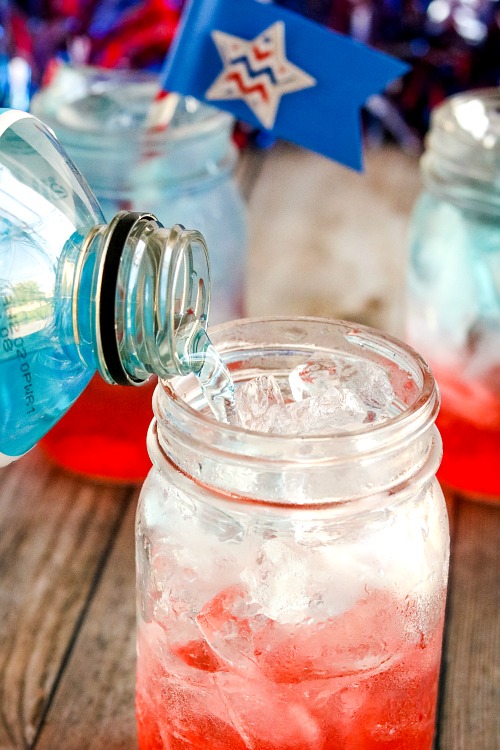Fourth of July or Memorial Day Drink Recipe- For a fun (and tasty) drink to serve at your next Memorial Day or Fourth of July party, make this red, white, and blue layered drink + DIY straw flags! | patriotic drink recipe, homemade drink, #drinkRecipe #FourthOfJuly #MemorialDay #ACultivatedNest