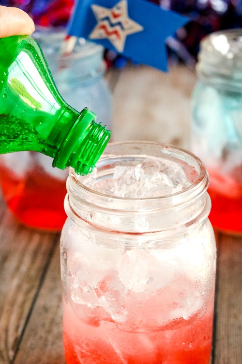 Patriotic Layered Drink Recipe- For a fun (and tasty) drink to serve at your next Memorial Day or Fourth of July party, make this red, white, and blue layered drink + DIY straw flags! | patriotic drink recipe, homemade drink, #drinkRecipe #FourthOfJuly #MemorialDay #ACultivatedNest