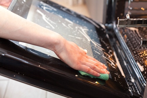 Cleaning Your Oven with a Homemade Cleaner- Tired of your oven being a mess? This huge oven cleaning guide has all the easiest ways to clean your oven, inside and out! | kitchen cleaning tips, clean oven glass, clean oven racks, #homemadeCleaningProducts #DIYCleaner #cleaningTips #ACultivatedNest