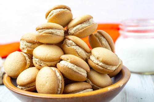 Mini Pumpkin Cheesecake Sandwich Cookies- These mini pumpkin cheesecake sandwich cookies are just the perfect snacking size! One isn't going to be enough and with one taste, you'll see why! | fall dessert recipes, autumn treat recipes, #recipe #pumpkin #dessert #cookies #ACultivatedNest