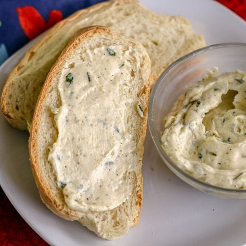 Easy Garlic Butter Recipe- As soon as you try this incredibly easy garlic butter recipe, you're sure to be hooked. It goes great with seafood, steak, vegetables, bread, and more! | roasted garlic butter, homemade spread, #recipe #homemade #butter #garlic #ACultivatedNest