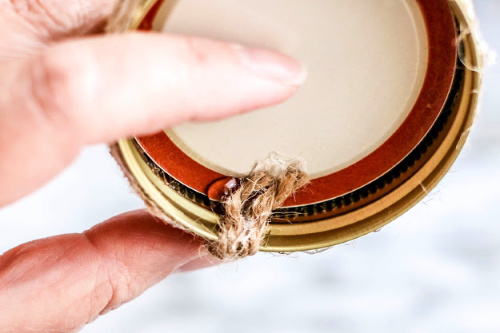 Rustic Christmas Tree Ornament Craft- This beautiful burlap Mason jar lid ornament is easy to make and would look lovely on your Christmas tree! It also makes a great DIY ornament gift! | homemade ornament, rustic Christmas ornament DIY, #ChristmasCraft #ChristmasOrnament #craft #DIY #ACultivatedNest