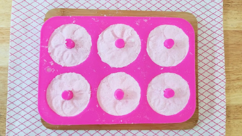 Strawberry Donut Bath Bomb Craft- Make this strawberry donut DIY bath bomb recipe to keep for yourself or give as gifts! They smell amazing and are easy to make! | #DIY #craft #bathBomb #diyGift #ACultivatedNest