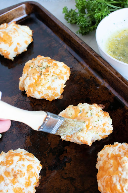 Cheddar Biscuits Recipe- Sink your teeth into these copycat Red Lobster Cheddar Bay Biscuits! They are soft, warm, packed with flavor and easy to make! | #copycatRecipes #recipe #biscuits #food #ACultivatedNest