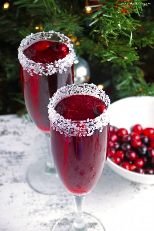 Cranberry Mimosa Recipe- This is the ultimate list of easy and delicious Christmas drink recipes. Serve them at your next holiday party and everyone will rave about them for sure! | holiday drink recipes, nonalcoholic drinks, kid friendly drinks, hot drinks, cold drinks, #recipe #drinks #ChristmasDrinks #alcoholicDrinks #ACultivatedNest