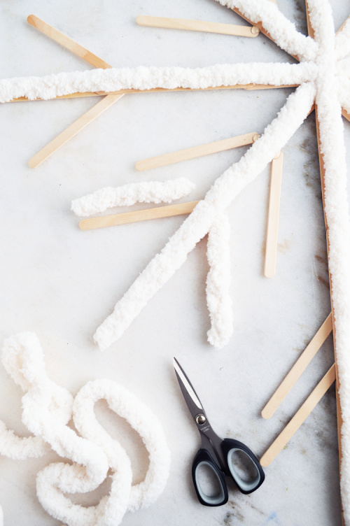 Giant Snowflakes Winter DIY- You can easily make these beautiful fluffy big DIY snowflakes to decorate your tree, mantle, or home. They add a touch of elegance to your space! | Christmas craft, frugal Christmas decorations, #DIY #Christmas #craft #ChristmasDecor #ACultivatedNest