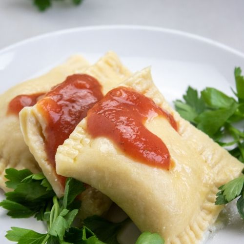 Easy Cheese Ravioli From Scratch- You won't believe how incredible cheese ravioli from scratch tastes! It's easy to make, loaded with flavor, and will put a smile on your face! | homemade pasta, #recipe #ravioli #vegetarian #food #ACultivatedNest