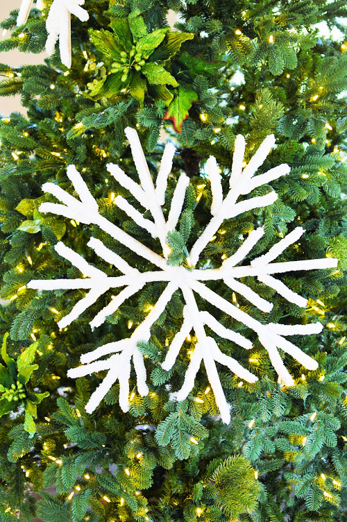 Giant Snowflakes Christmas DIY- You can easily make these beautiful fluffy big DIY snowflakes to decorate your tree, mantle, or home. They add a touch of elegance to your space! | Christmas craft, frugal Christmas decorations, #DIY #Christmas #craft #ChristmasDecor #ACultivatedNest