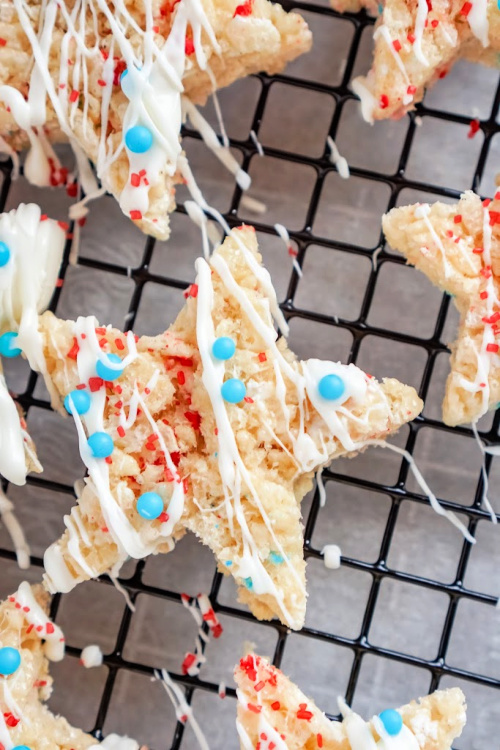 Patriotic Rice Krispie Treat Dessert Recipe- Celebrate patriotic holidays in style with these delicious patriotic rice krispie treat stars! They are festive, fun, and a crowd-pleaser! | homemade krispy rice treat recipes, red, white, and blue food recipes, patriotic dessert recipes, #memorialDay #fourthOfJuly #riceKrispieTreats #dessertRecipe #ACultivatedNest