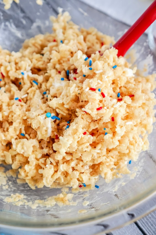 Fourth of July Rice Krispie Treat Stars- Celebrate patriotic holidays in style with these delicious patriotic rice krispie treat stars! They are festive, fun, and a crowd-pleaser! | homemade krispy rice treat recipes, red, white, and blue food recipes, patriotic dessert recipes, #memorialDay #fourthOfJuly #riceKrispieTreats #dessertRecipe #ACultivatedNest
