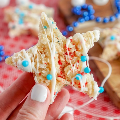 Patriotic Rice Krispie Treat Stars- Celebrate patriotic holidays in style with these delicious patriotic rice krispie treat stars! They are festive, fun, and a crowd-pleaser! | homemade krispy rice treat recipes, red, white, and blue food recipes, patriotic dessert recipes, #memorialDay #fourthOfJuly #riceKrispieTreats #dessertRecipe #ACultivatedNest