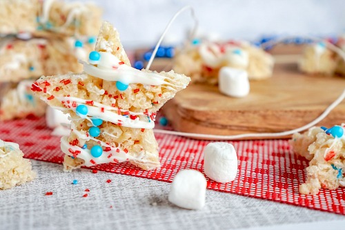 Patriotic Homemade Rice Krispie Treat Stars- Celebrate patriotic holidays in style with these delicious patriotic rice krispie treat stars! They are festive, fun, and a crowd-pleaser! | homemade krispy rice treat recipes, red, white, and blue food recipes, patriotic dessert recipes, #memorialDay #fourthOfJuly #riceKrispieTreats #dessertRecipe #ACultivatedNest