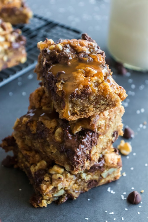 Delectable Salted Caramel Cookie Bars- One taste of these delectable salted caramel cookie bars and you will be addicted! They are soft, chewy, and full of chocolate, caramel, and nuts. | #recipe #dessert #caramel #chocolate #ACultivatedNest