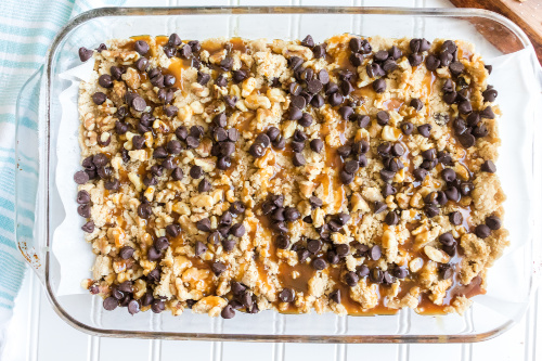 Homemade Caramel Chocolate Cookie Bars Recipe- One taste of these delectable salted caramel cookie bars and you will be addicted! They are soft, chewy, and full of chocolate, caramel, and nuts. | #recipe #dessert #caramel #chocolate #ACultivatedNest