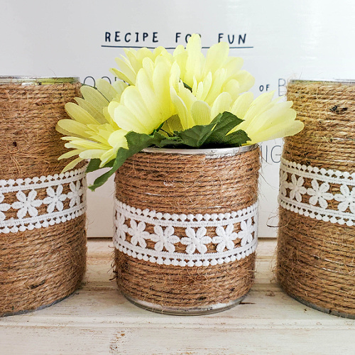 Twine and Lace Upcycled Cans Craft- Don't throw out your tin cans! Instead, use them to make this cute twine and lace upcycled cans craft! This makes a great décor piece, or desk organizer! | #upcycle #craft #upcycling #diyProject #ACultivatedNest