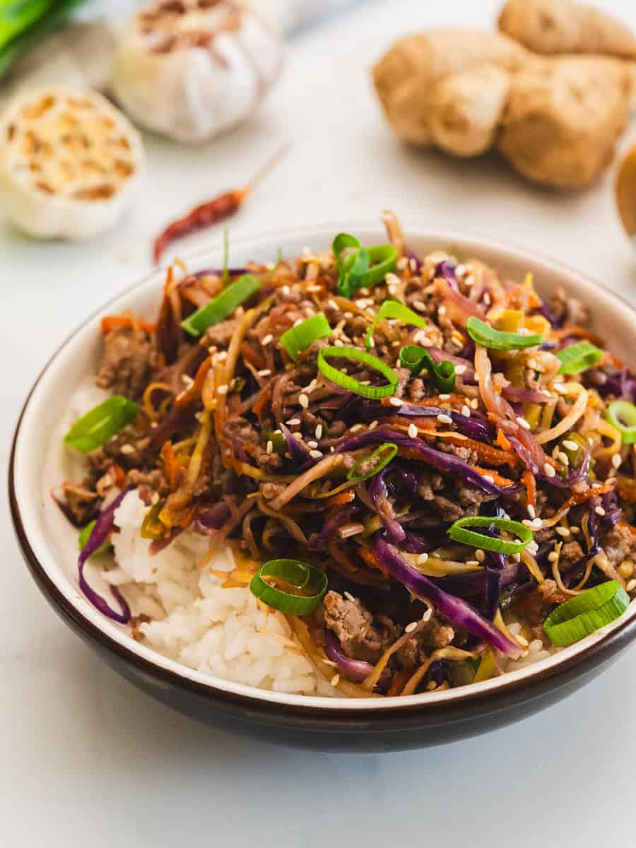 10 Delicious Ways to Eat More Cabbage- Looking for healthy ways to use that head of cabbage in your fridge? From 20-minute turkey egg roll bowls to crispy roasted cabbage steaks and slow-cooker comfort food, these delicious recipes make it easy to add more nutrients to your diet! These budget-friendly, family-approved meals are perfect for quick weeknight dinners or simple side dishes. Click to find your new favorite way to cook cabbage! | #HealthyRecipes #CabbageRecipes #CleanEating #ACultivatedNest